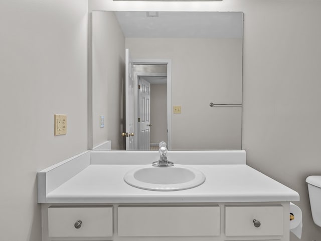 bathroom featuring toilet and vanity