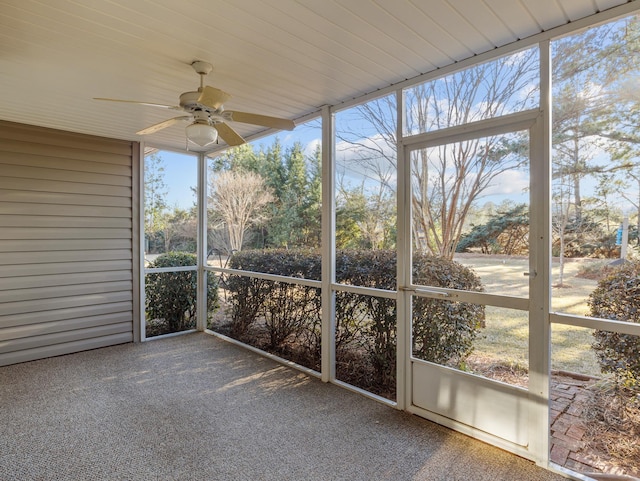 unfurnished sunroom with ceiling fan