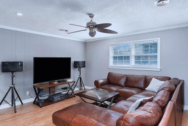 living room with ceiling fan, hardwood / wood-style floors, crown molding, and a textured ceiling