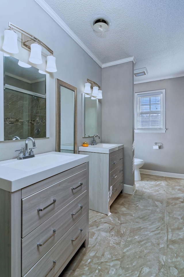 bathroom with toilet, vanity, ornamental molding, a shower with shower door, and a textured ceiling