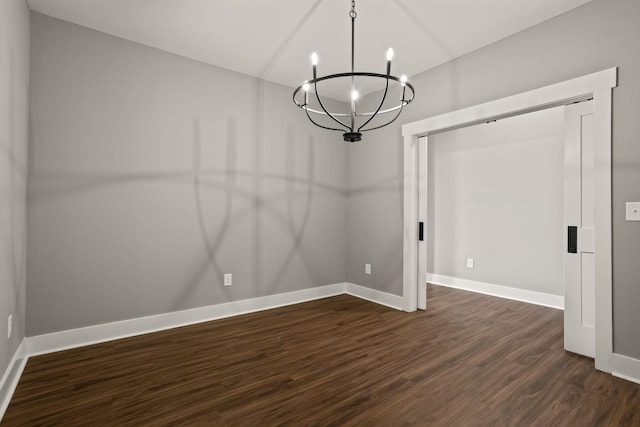 unfurnished dining area featuring dark wood-type flooring and an inviting chandelier