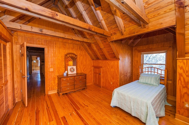 bedroom with wood walls, light hardwood / wood-style flooring, and wooden ceiling