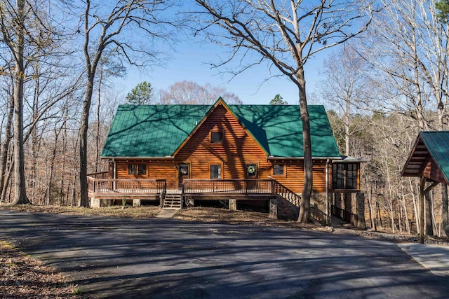 log cabin featuring a deck