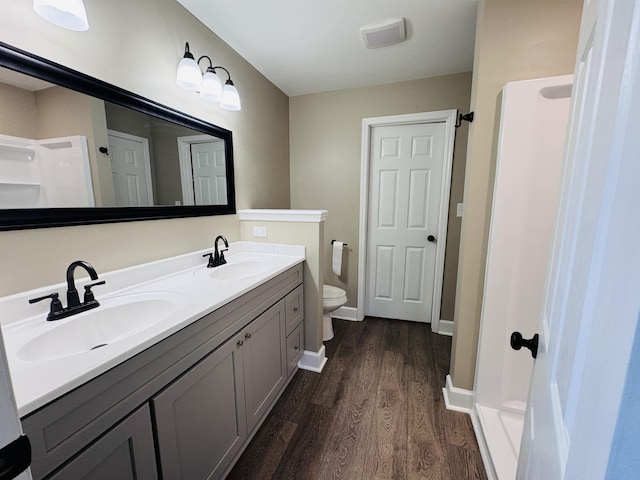 bathroom with toilet, walk in shower, wood-type flooring, and vanity