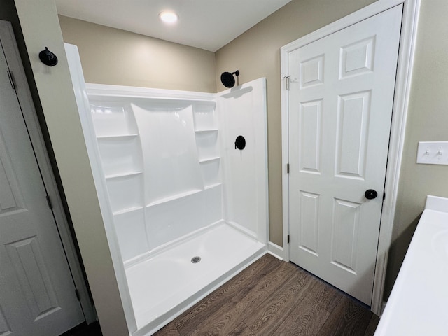 bathroom with wood-type flooring and walk in shower