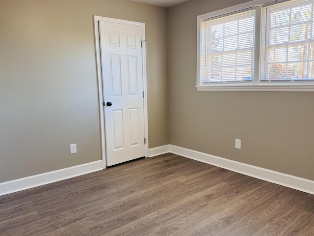 unfurnished room with hardwood / wood-style flooring