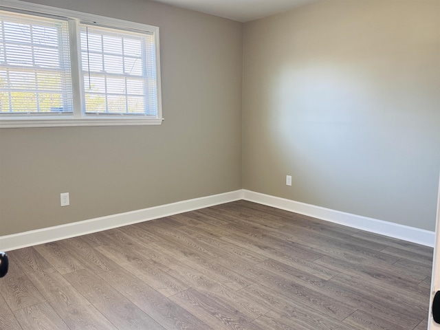 spare room with hardwood / wood-style flooring