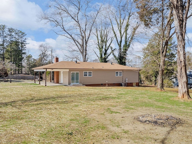 rear view of house with a yard and a patio