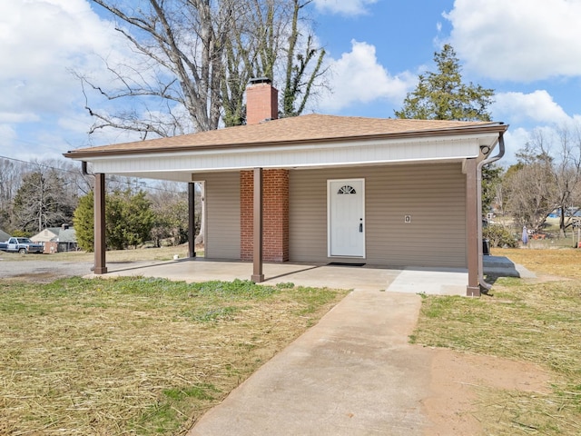 view of front of home with a carport and a front yard