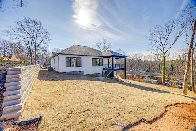 rear view of house with central AC unit