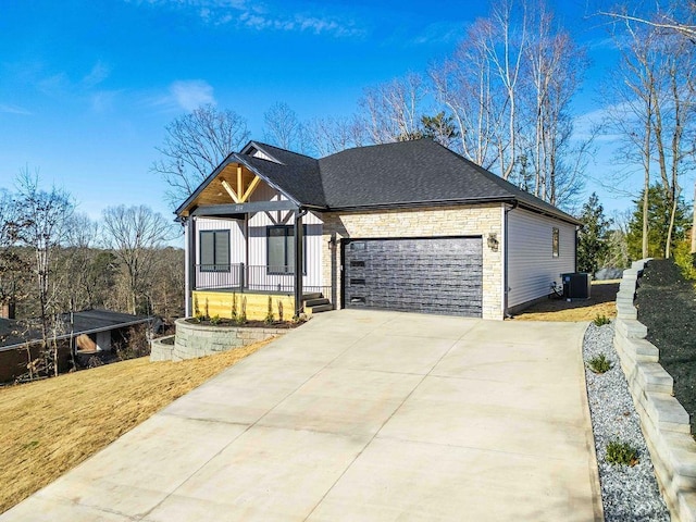 view of front of house featuring cooling unit and a garage