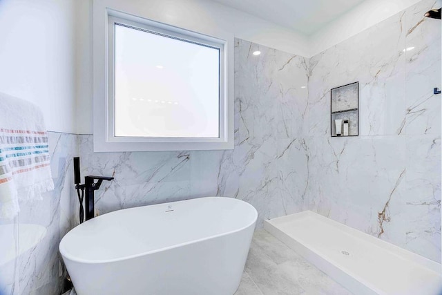 bathroom featuring shower with separate bathtub, tile walls, and a wealth of natural light