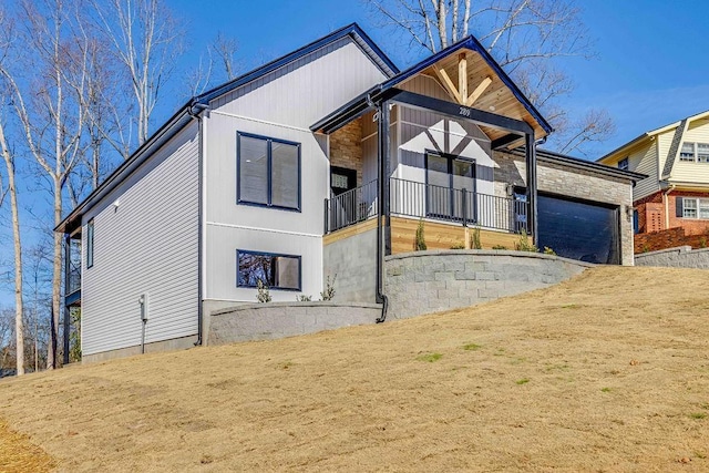 view of front of home with a balcony and a garage