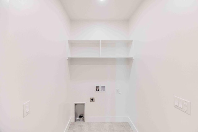 laundry area featuring electric dryer hookup, washer hookup, and light tile patterned floors