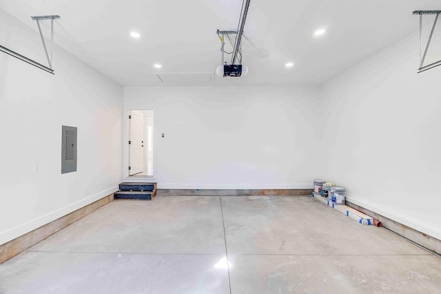 garage with electric panel and a garage door opener