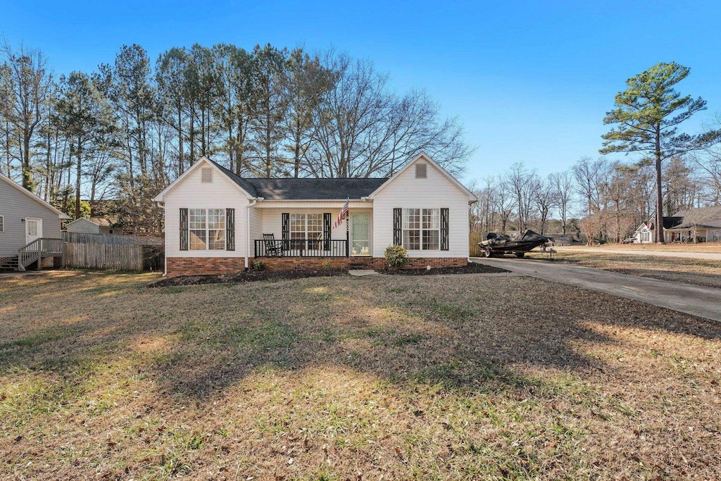 view of front of property with covered porch and a front lawn