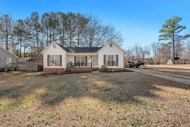 view of front of property with covered porch and a front lawn