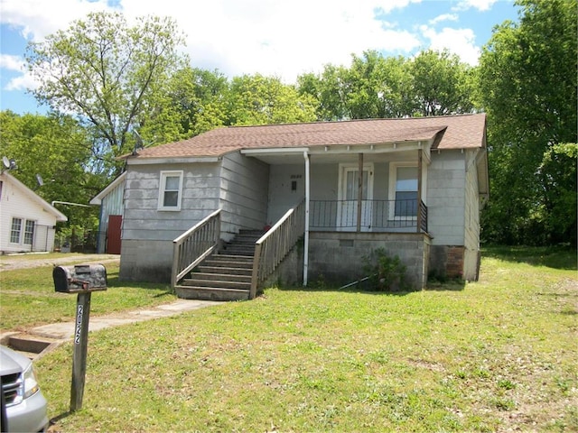 bungalow-style house with a front yard and covered porch