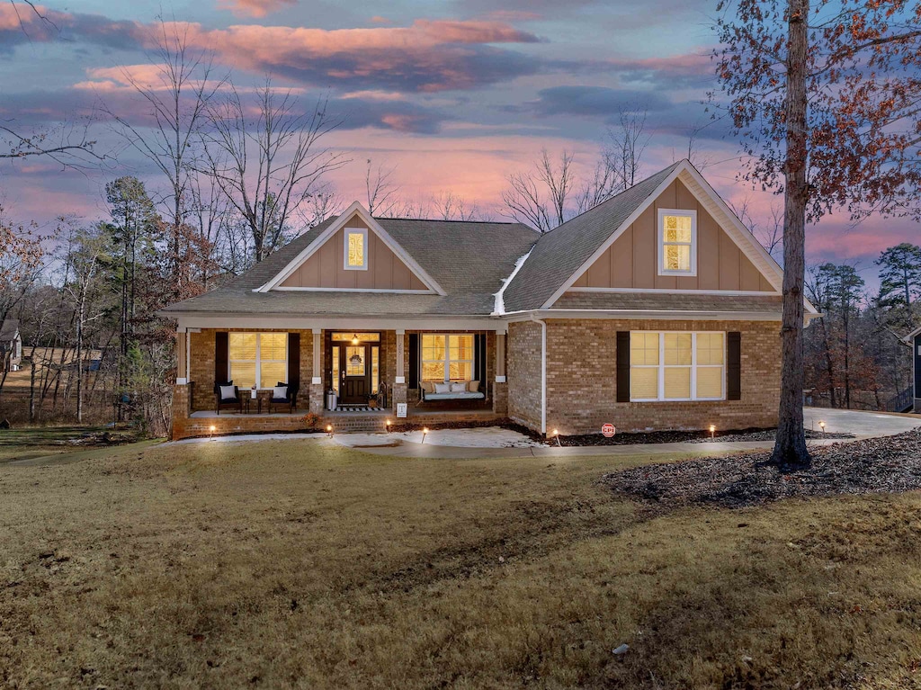 craftsman-style house featuring a yard and a porch