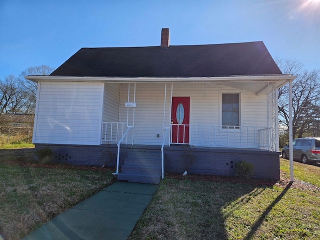 view of front of home featuring a front yard and a porch