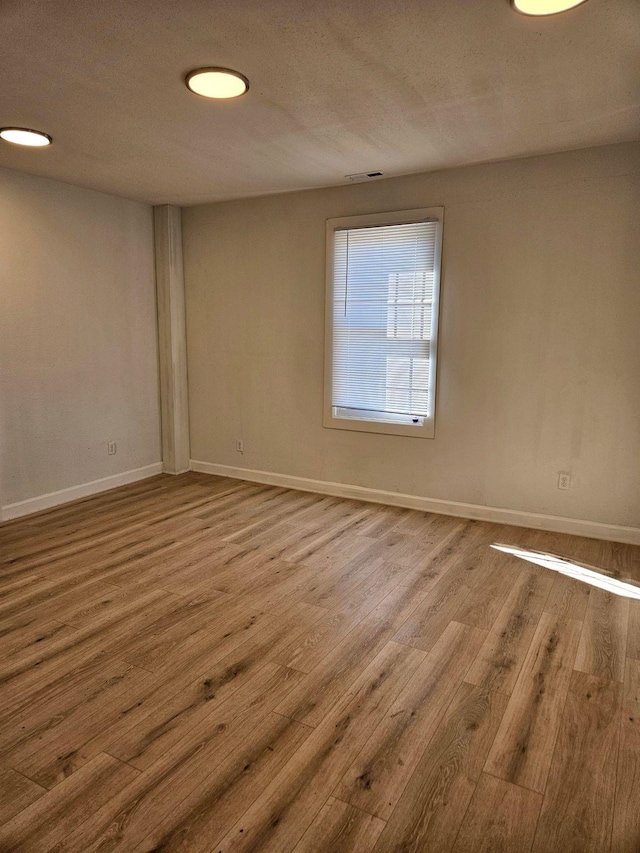 unfurnished room featuring hardwood / wood-style floors