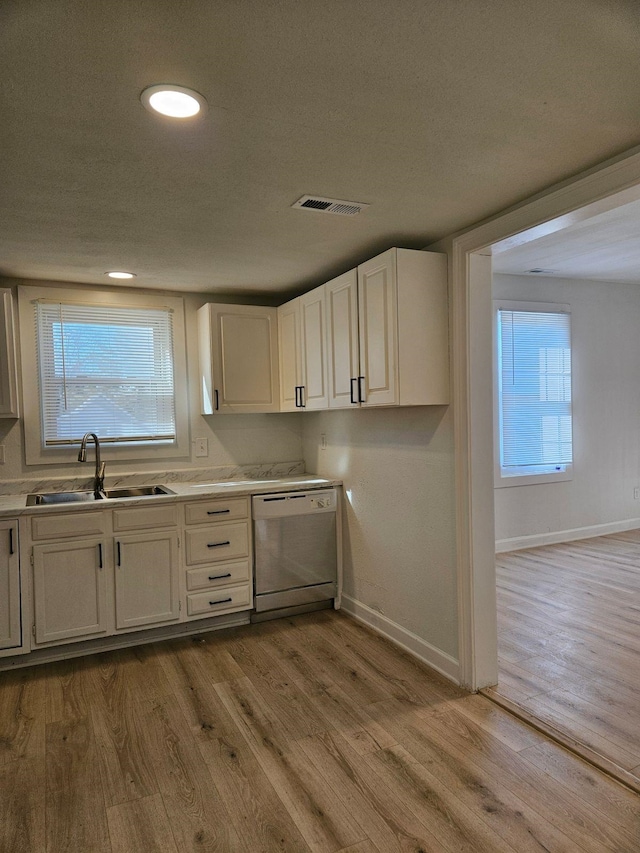 kitchen featuring light hardwood / wood-style floors, sink, white cabinetry, and dishwasher