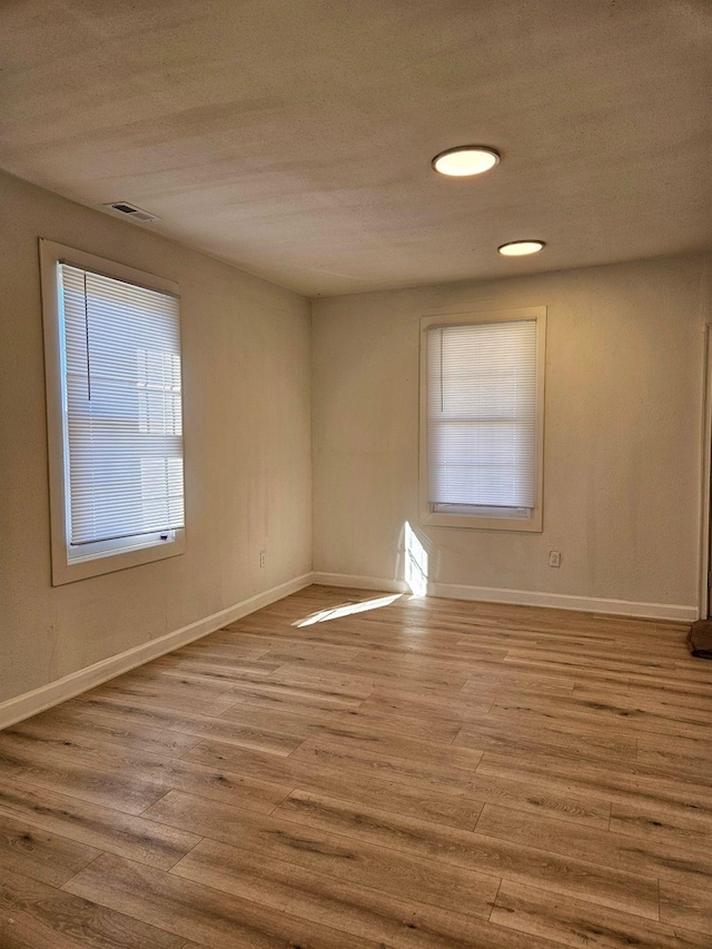 spare room featuring light hardwood / wood-style flooring