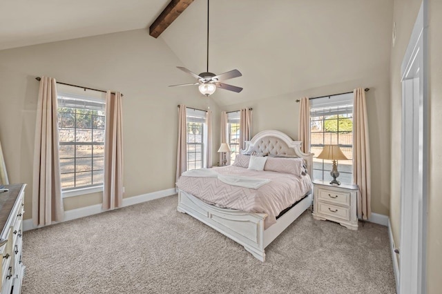 bedroom with ceiling fan, light colored carpet, multiple windows, and beam ceiling