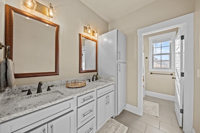 bathroom with vanity and tile patterned flooring