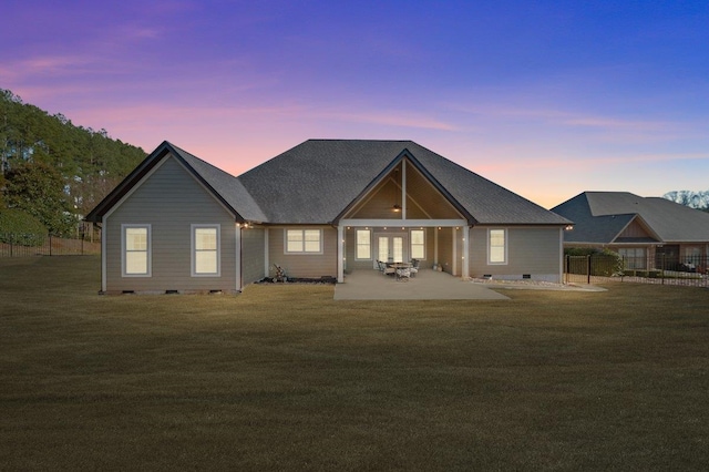 view of front of home with a yard and a patio