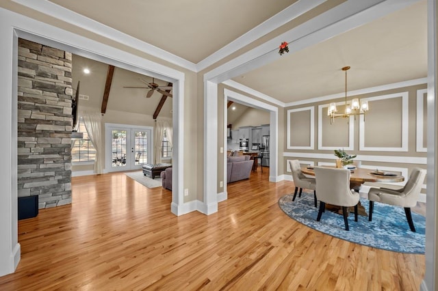 dining area with ceiling fan with notable chandelier, french doors, vaulted ceiling with beams, ornamental molding, and light wood-type flooring