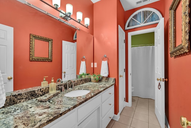 bathroom with tile patterned floors, vanity, and toilet