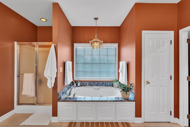 bathroom with a textured ceiling, independent shower and bath, tile patterned flooring, and an inviting chandelier