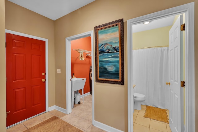 entryway with light tile patterned flooring