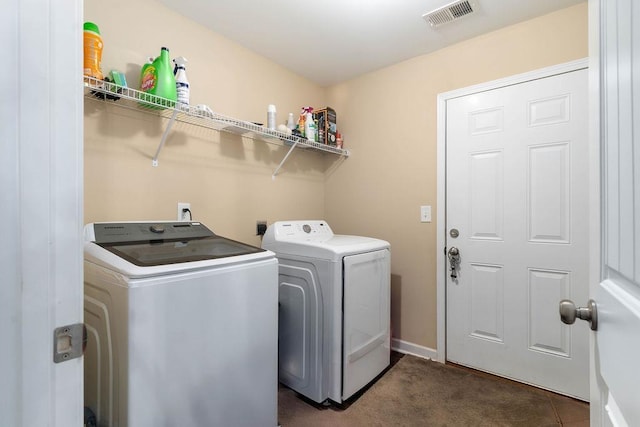 washroom with washing machine and clothes dryer