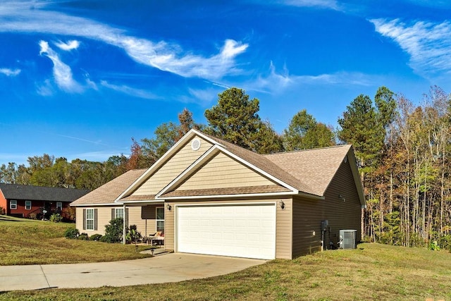 view of front of home with a garage, a front yard, and central air condition unit