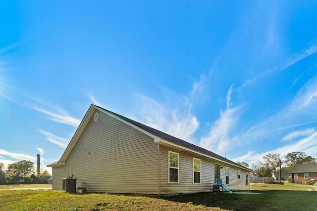 view of home's exterior with central AC and a lawn