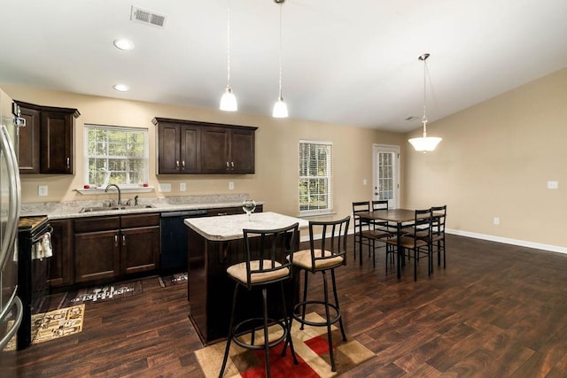 kitchen with a center island, decorative light fixtures, dark wood-type flooring, black appliances, and sink