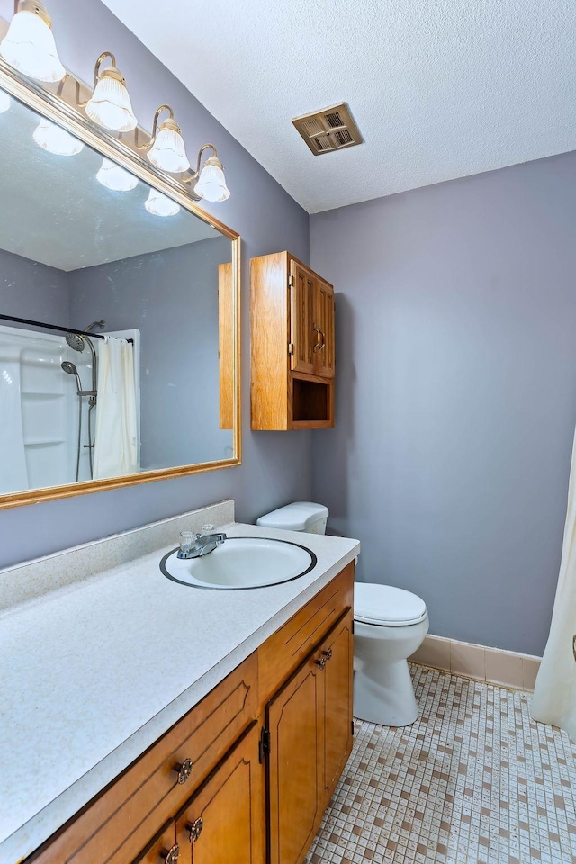 bathroom featuring toilet, vanity, tile patterned flooring, a shower with curtain, and a textured ceiling