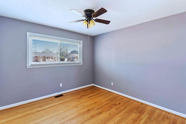 unfurnished room with ceiling fan and light wood-type flooring