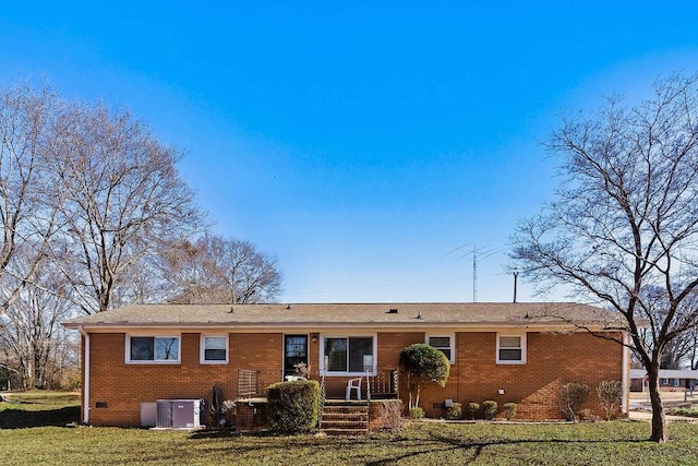 rear view of house featuring a yard and central AC