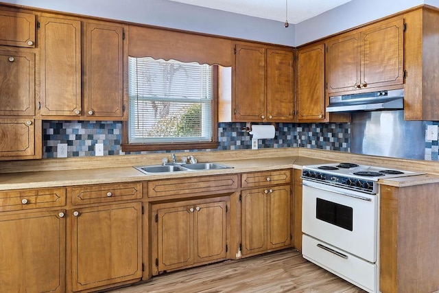 kitchen featuring light wood-type flooring, sink, decorative backsplash, and white range