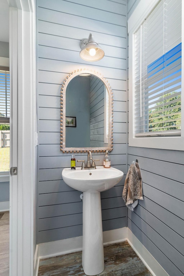 bathroom featuring wood walls and hardwood / wood-style floors