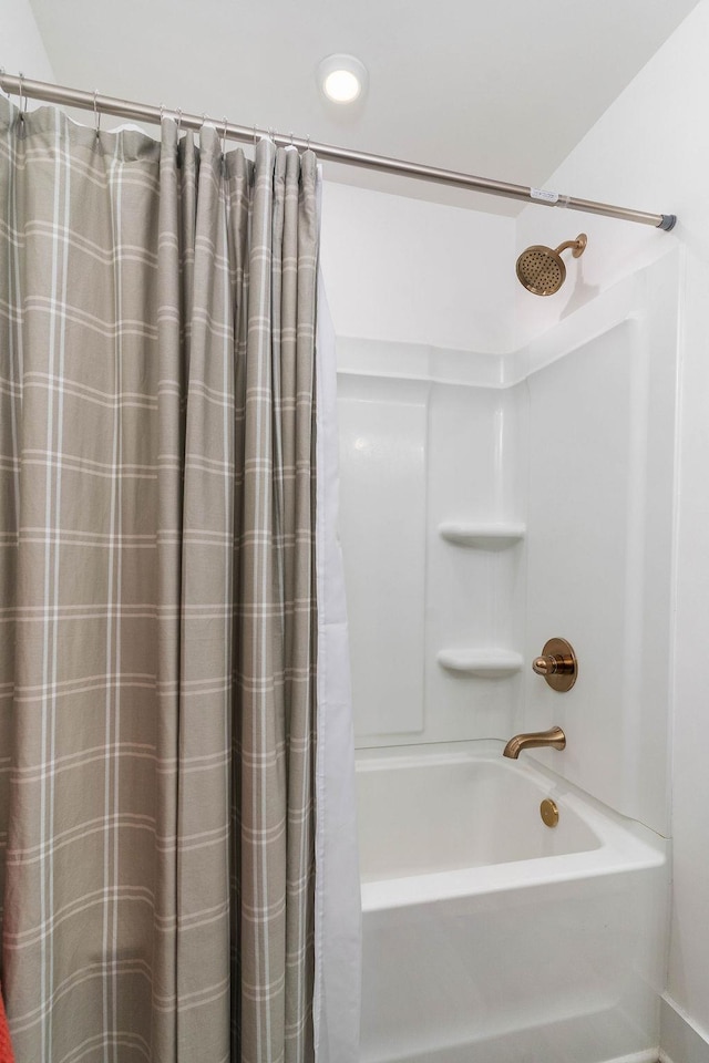 bathroom featuring shower / bathtub combination with curtain