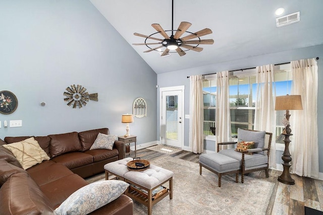 living room with ceiling fan, hardwood / wood-style floors, and high vaulted ceiling