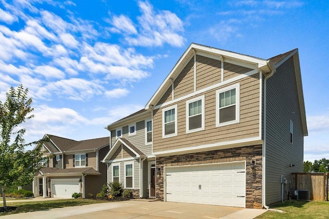 craftsman-style home featuring a garage and cooling unit