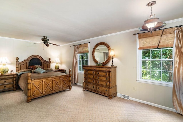 carpeted bedroom featuring ceiling fan and crown molding