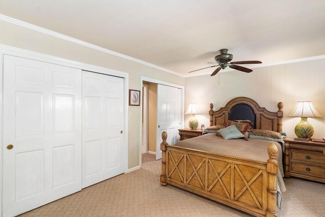 carpeted bedroom with ceiling fan, two closets, and crown molding