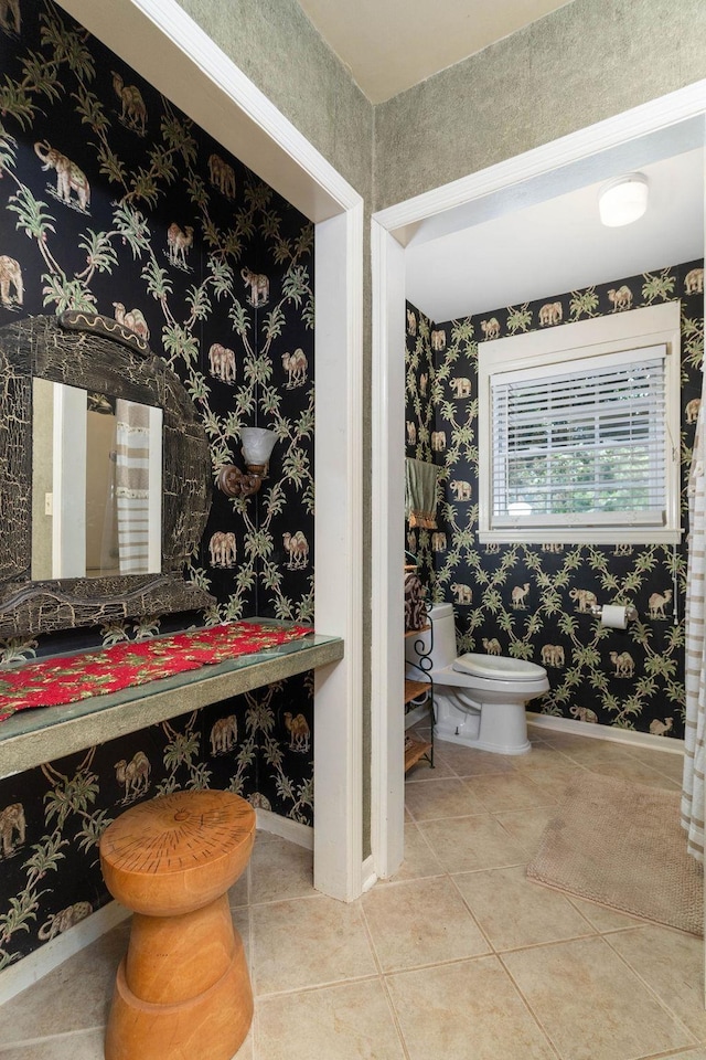 bathroom featuring toilet and tile patterned flooring