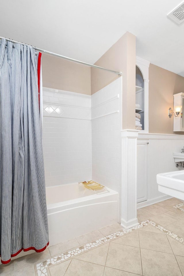 bathroom featuring tile patterned flooring and shower / bath combo with shower curtain